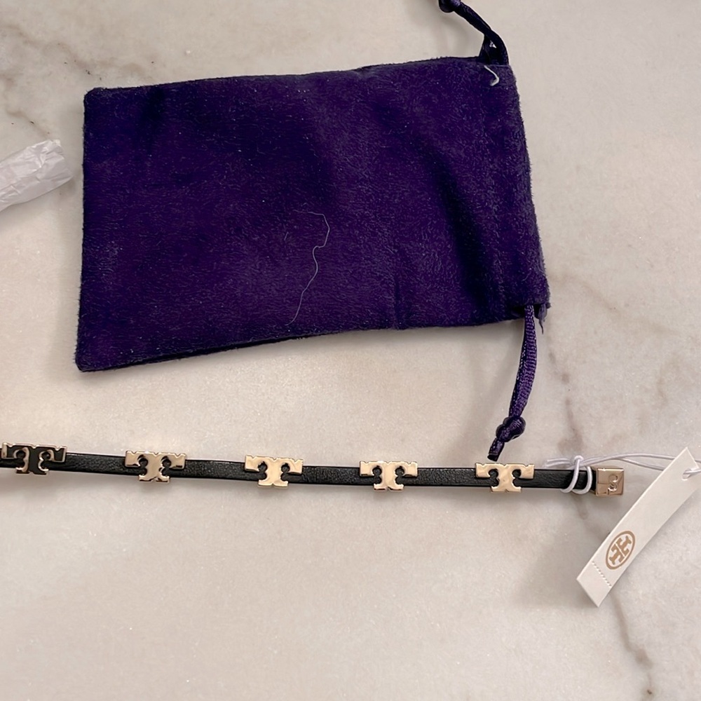 Tory Burch, black leather bracelet with gold hardware.